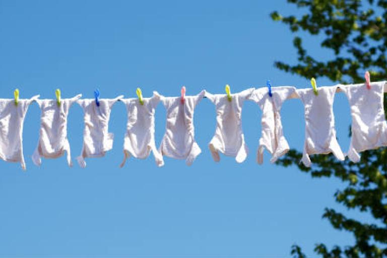 washing line with many cloth nappies drying 
