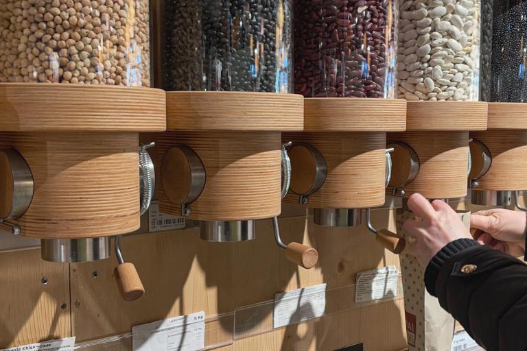 Reusable containers with dry ingredients in a refill shop.