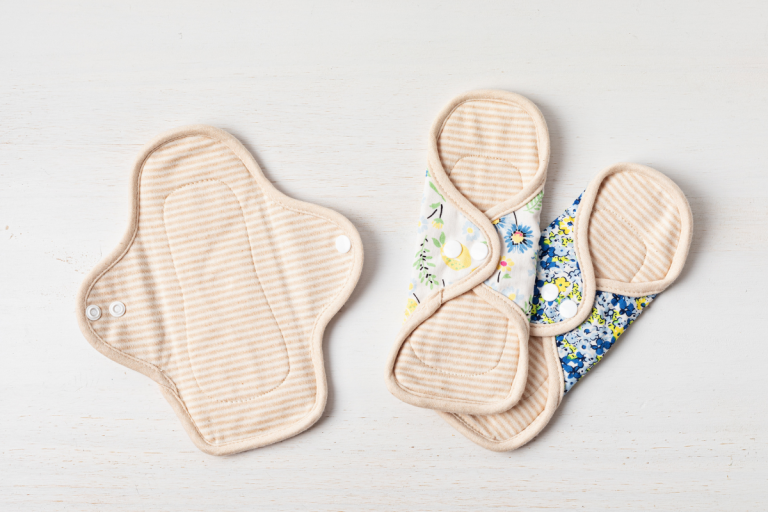 Three reusable period pads laid on white background.