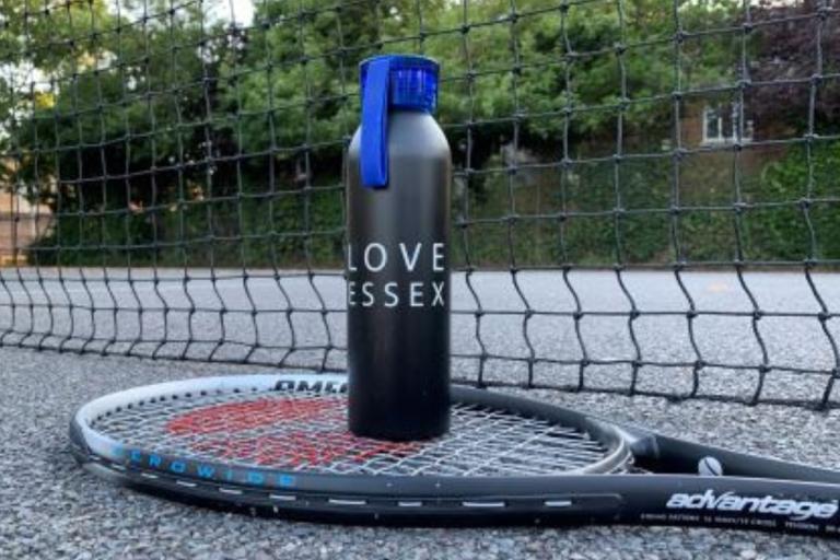 Reusable water bottle on a tennis racket.