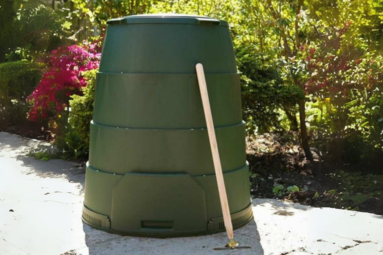 A Green Johanna compost bin in a garden