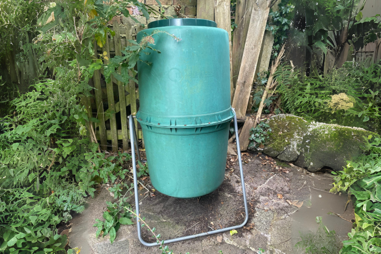 Tumbler compost bin in garden