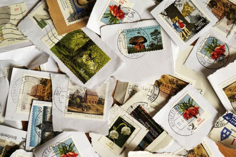 Aerial view of stamps spread out on table.