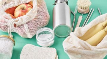 Selection of plastic free products on a green surface.